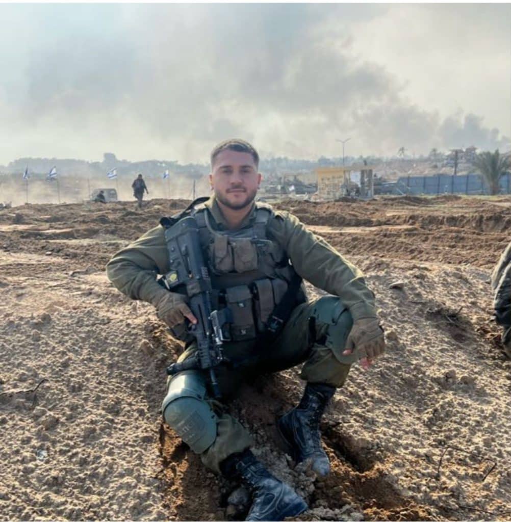 Nisim Kachlon z"l with military vest and m16 sitting on ground