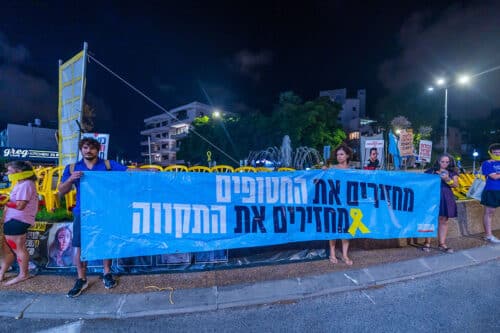 demonstrators with sign - 'return hostages: return the hope'